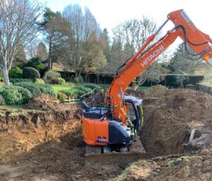 groundco_of_godalming_residential_groundworks_agricultural_groundworks_industrial_groundworks_commercial_groundworks_godalming_surrey_groundworks_company_60_years_experience_foundation_preparation_surrey_sussex_hampshire_groundwork_specialists_underground_surveying_pre_build_surveying_ecology_land_clearance_scrub_clearance_demolition_services_mass_digging_spoil_muck_away_drainage_installation_water_management_preparation_ditch_clearance_utility_connection_groundwork_water_gas_electricity_concrete_structures_concrete_slab_installation_reinforced_concrete_foundations_helical_soil_stabilisation_ground_screw_foundations_ground_screw_grillage_systems_road_construction_path_construction_block_paving_tarmac_driveways_tarmac_road_installation_agricultural_access_tracks_equestrian_groundworks_bridleway_groundworks_horse_training_menages_menage_drainage_menage_fencing_equestrian_arenas_rubber_surfaces_equestrian_concrete_yards_concrete_stable_bases